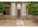 Charming single story home featuring a decorative steel front door and stone accents at 2308 S Bernard --, Mesa, AZ 85209