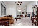 Bright living room with large windows, fireplace, and tile floors, perfect for relaxation at 2308 S Bernard --, Mesa, AZ 85209