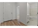 Bright entryway with wood floors leading to the bathroom and bedroom at 23443 W Albeniz Pl, Buckeye, AZ 85326