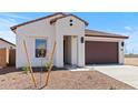 Modern single-story home with desert landscaping, a two-car garage and stylish architectural details at 23443 W Albeniz Pl, Buckeye, AZ 85326