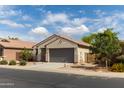 Lovely single-story home with a two-car garage and well-maintained landscaping at 25028 W Wayland Dr, Buckeye, AZ 85326