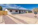 A single-story home featuring a concrete driveway and low-maintenance landscaping at 2540 E Hartford Ave, Phoenix, AZ 85032