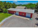 Large red barn with multiple bays and a white fence for a rural feel at 25829 S Mandarin Dr, Queen Creek, AZ 85142