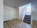 Bright entryway featuring wood-look floors and a staircase leading to the second floor at 272 S 228Th Ln, Buckeye, AZ 85326