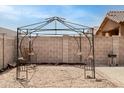 Backyard view with a decorative pergola under construction in a gravel landscape, ready for summer relaxation and outdoor enjoyment at 2723 W Apollo Rd, Phoenix, AZ 85041