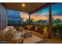 Cozy covered patio with comfortable seating and string lights at 3929 E Bloomfield Pkwy, Gilbert, AZ 85296