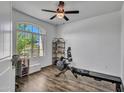 Bright bedroom features wood floors, an arched window, and a ceiling fan at 4132 W Tunnel Mine Rd, New River, AZ 85087