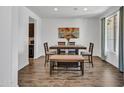 Inviting dining area is complete with wood floors, a table, and chairs at 4132 W Tunnel Mine Rd, New River, AZ 85087