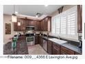 Well-equipped kitchen with dark wood cabinetry, stainless steel appliances, and ample counter space at 4366 E Lexington Ave, Gilbert, AZ 85234