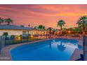 Backyard with a sparkling pool and covered patio area at 5402 E Larkspur Dr, Scottsdale, AZ 85254