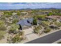 Stunning aerial view of the home showcasing the desert landscape and mountain views at 7486 E Bajada Rd, Scottsdale, AZ 85266