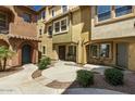 Charming townhouse exteriors featuring landscaped walkways connecting residences, creating a welcoming community atmosphere at 7722 W Pipestone Pl, Phoenix, AZ 85035