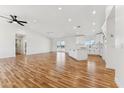 Bright open-concept living space features hardwood floors, recessed lighting, and a ceiling fan at 9280 W Wenden Dr, Arizona City, AZ 85123