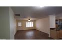 Inviting living area features vinyl floors, large windows, and neutral paint palette at 1033 S Florence Dr, Mesa, AZ 85208