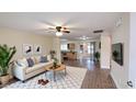 Bright open-plan living room featuring a comfortable seating area and seamless flow to the kitchen space at 1033 S Florence Dr, Mesa, AZ 85208