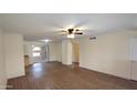 Bright and airy living room with wood floors, fan, and slider doors to patio at 1033 S Florence Dr, Mesa, AZ 85208