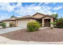 Beautiful one-story home with desert landscaping, a neutral color scheme, and a two-car garage at 10752 W Rio Vista Ln, Avondale, AZ 85323