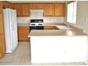 Efficient kitchen with wood cabinets, laminate countertops and modern appliances at 10752 W Rio Vista Ln, Avondale, AZ 85323
