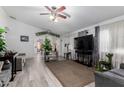 Cozy living room featuring modern vinyl floors, neutral paint, plush seating, and a ceiling fan at 10752 W Rio Vista Ln, Avondale, AZ 85323