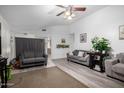 Open-concept living room with neutral decor, vinyl flooring, comfortable sofas, and access to dining area at 10752 W Rio Vista Ln, Avondale, AZ 85323