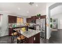 Modern kitchen with stainless steel appliances, granite countertops, and a stylish backsplash at 12041 W Melinda Ln, Sun City, AZ 85373