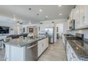 Bright, open kitchen with a large island, granite countertops, stainless steel appliances, and wood-look tile flooring at 12048 E Chevelon Trl, Gold Canyon, AZ 85118