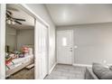 Bright foyer featuring neutral paint, tile flooring, closet, and a view into the bedroom at 12543 W Roanoke Ave, Avondale, AZ 85392