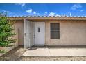 Front door with screen door and pink flowering bush to the side at 12543 W Roanoke Ave, Avondale, AZ 85392