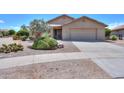 Inviting single-story home with desert landscaping and a covered entryway, plus a two car garage at 135 S Verde Ln, Casa Grande, AZ 85194