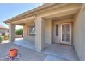 Welcoming covered front porch with neutral tones, sturdy columns, and an decorative security door at 135 S Verde Ln, Casa Grande, AZ 85194