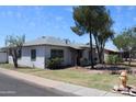 Classic single-story home showcasing a neatly landscaped yard at 1367 E Clarendon Ave, Phoenix, AZ 85014