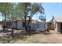 Side view of house, including fenced area with a satellite dish on the roof at 1367 E Clarendon Ave, Phoenix, AZ 85014