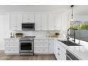 Modern kitchen with stainless steel appliances, white cabinets, and elegant quartz countertops at 14945 N 102Nd St, Scottsdale, AZ 85255