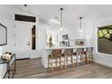 Bright, eat-in kitchen with white cabinets, quartz countertops, and a breakfast bar with seating at 14945 N 102Nd St, Scottsdale, AZ 85255