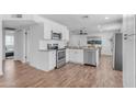 Bright kitchen features white cabinets, stainless steel appliances, and hardwood flooring at 1511 E Harmony Ave, Mesa, AZ 85204