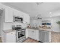 Modern kitchen features stainless steel appliances, white cabinets, and granite countertops at 1511 E Harmony Ave, Mesa, AZ 85204