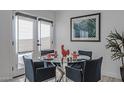 Cozy dining area with glass table, seating for four, and natural light from the glass doors at 1539 W Puget Ave, Phoenix, AZ 85021