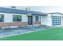 A charming home features a brick facade, glass garage door, and neatly landscaped front yard at 1539 W Puget Ave, Phoenix, AZ 85021