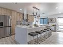 Spacious kitchen with large center island, modern lighting and stainless steel refrigerator at 1539 W Puget Ave, Phoenix, AZ 85021