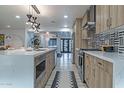 Bright kitchen with a center island, stainless steel appliances, and modern light fixtures at 1539 W Puget Ave, Phoenix, AZ 85021