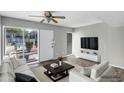 Staged living area with wood-look floors, a ceiling fan, and a bright, airy feel at 1828 W Tuckey Ln # 13, Phoenix, AZ 85015