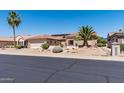 View of charming one-story home with tile roof, desert landscaping, and attached garage, offering curb appeal at 20394 N Coronado Way, Surprise, AZ 85374