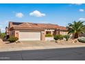 Inviting single-Gathering home with a well-maintained lawn, desert landscaping, tile roof, and a two-car garage at 20394 N Coronado Way, Surprise, AZ 85374