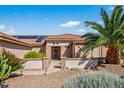 Charming one-story home with a tile roof, desert landscaping, and an inviting entrance in a sunny neighborhood at 20394 N Coronado Way, Surprise, AZ 85374