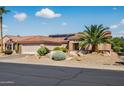 Beautiful one-story home with desert landscaping, a terracotta-colored roof, and solar panels for energy efficiency at 20394 N Coronado Way, Surprise, AZ 85374