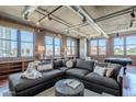 Stylish living room with industrial touches, large sectional sofa, exposed brick, lots of natural light, and custom built-ins at 21 E 6Th St # 316, Tempe, AZ 85281