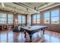 Bright living room featuring a pool table, hardwood floors, exposed duct work, and many large windows offering city views at 21 E 6Th St # 316, Tempe, AZ 85281