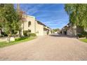 Beautiful townhouse exterior with brick driveway, grass, and lush greenery at 2142 E Turney Ave # 9, Phoenix, AZ 85016