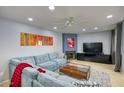 Cozy living room featuring a corner fireplace, large sectional couch, and modern decor at 2142 E Turney Ave # 9, Phoenix, AZ 85016