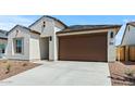 Charming home featuring a low-maintenance landscape and a two-car garage at 23404 W Burton Ave, Buckeye, AZ 85326
